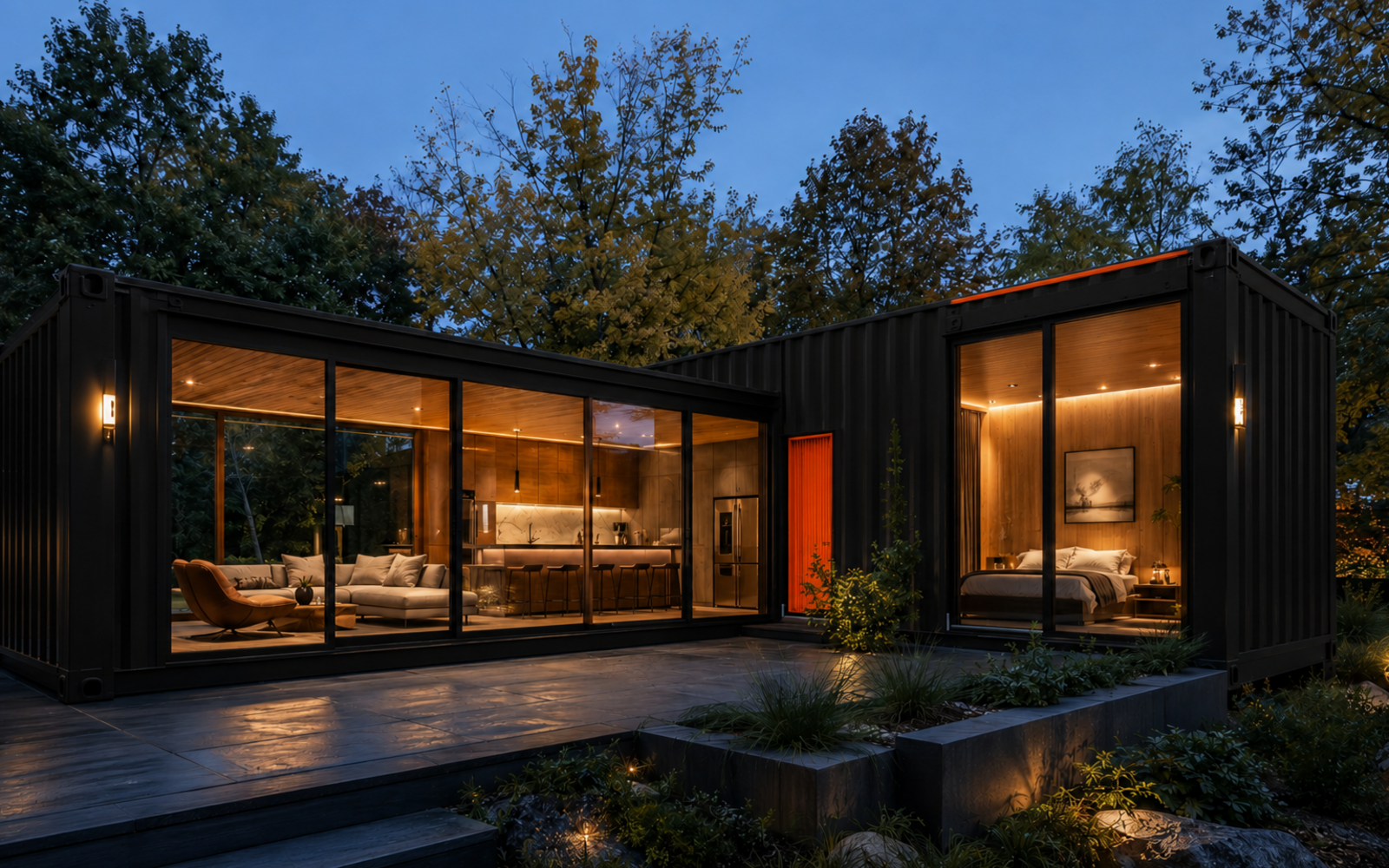 Luxury black container ADU with orange trim, large windows, and residential entry